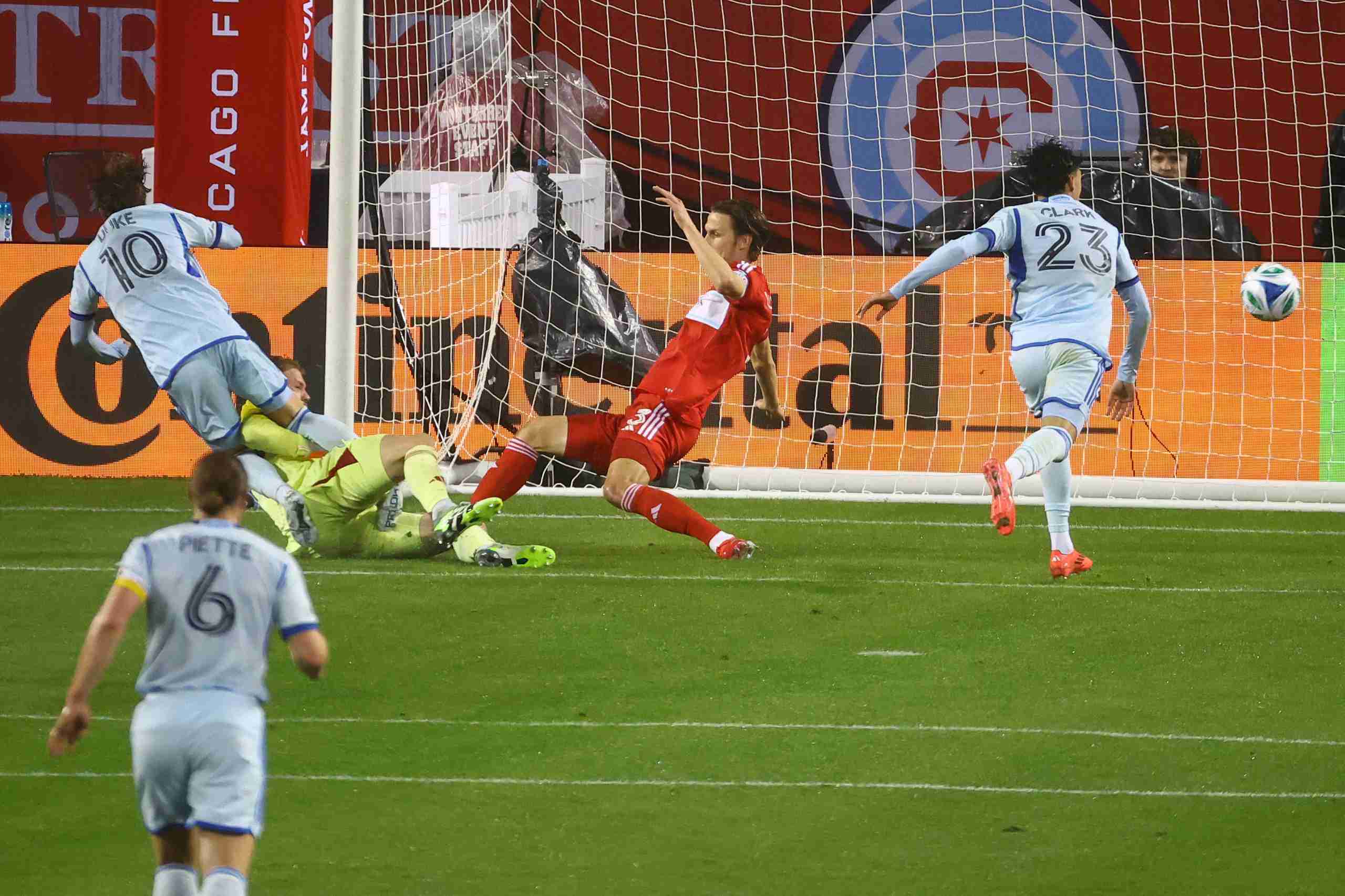 Mar 29, 2025; Chicago, Illinois, USA; Chicago Fire FC goalkeeper Chris Brady (34) makes a save agisant CF Montreal midfielder Bryce Duke (10) during the second half at Soldier Field. Mandatory Credit: Mike Dinovo-Imagn Images