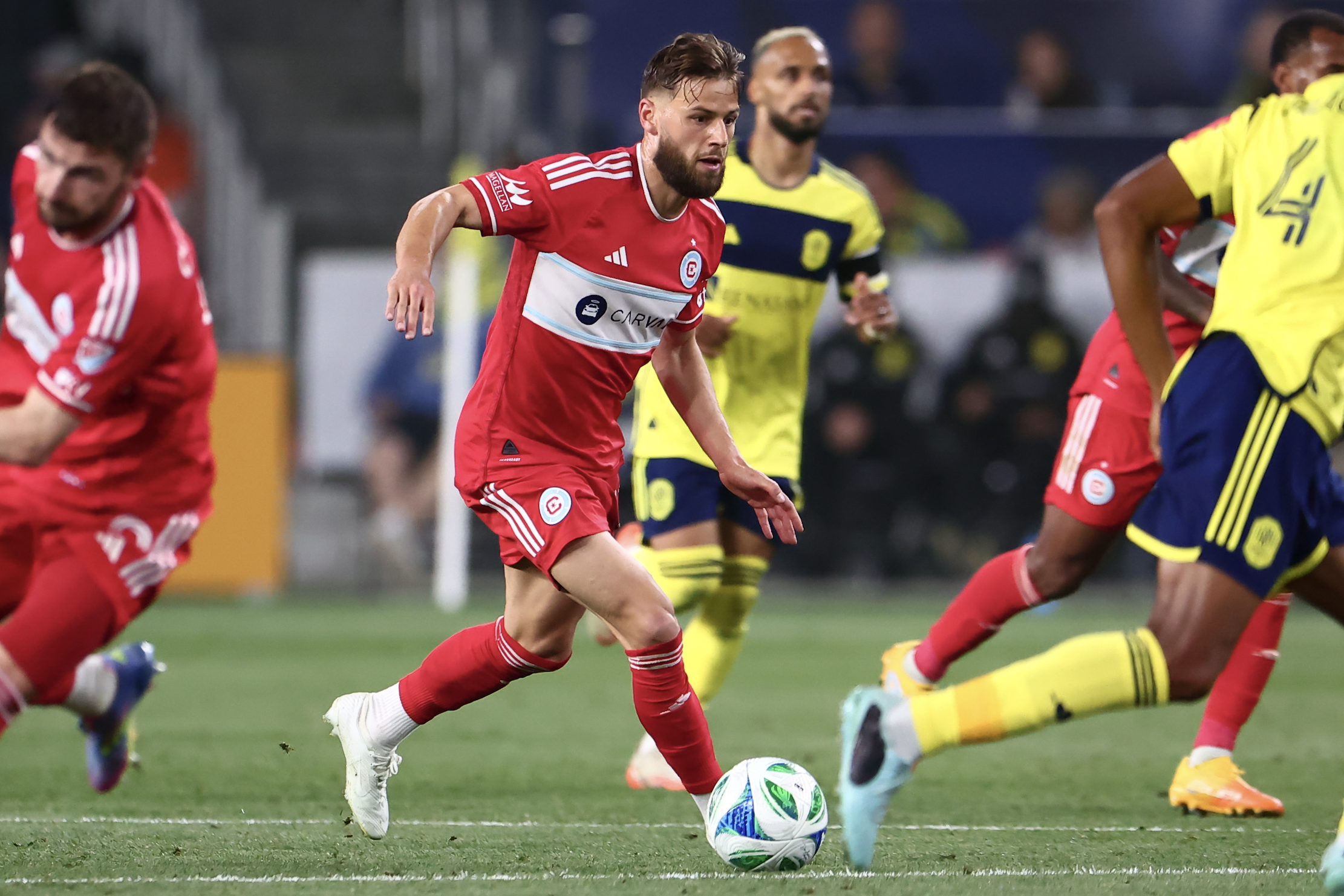 Apr 26, 2025; Nashville, Tennessee, USA; Chicago Fire forward Philip Zinckernagel (11) kicks the ball down the field in the second half of the match against Nashville SC at Geodis Park. Mandatory Credit: Casey Gower-Imagn Images